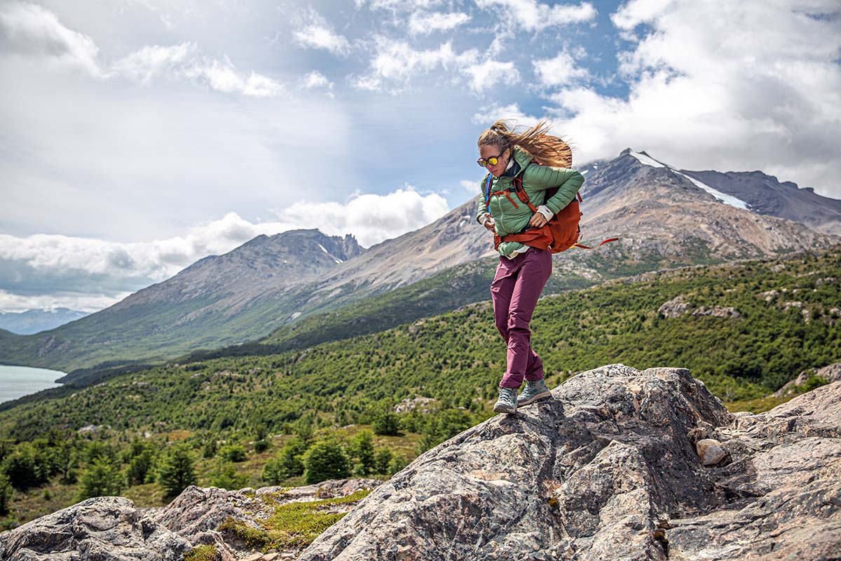 Hiking on rocks in the Helly Hansen Verglas down jacket